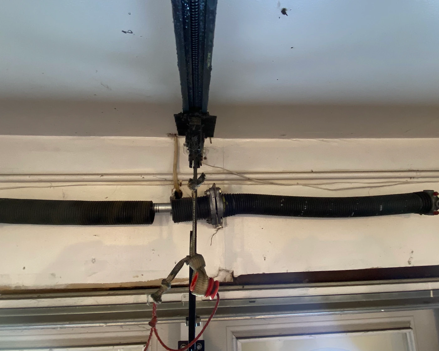 Before repair: broken garage door spring